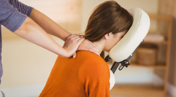 Young,Woman,Getting,Massage,In,Chair,In,Therapy,Room